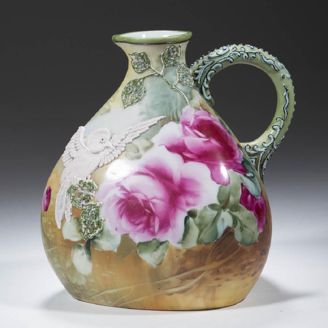NIPPON PORCELAIN MORIAGE BIRD EWER / WINE JUG: NIPPON PORCELAIN MORIAGE BIRD EWER / WINE JUG, wide base and narrow neck with one loop handle, hand-painted polychrome rose design over green ground with raised white moriage bird design on one side,