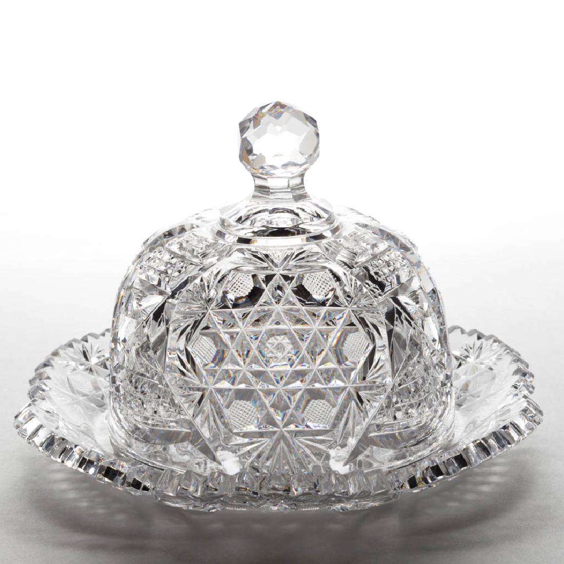 AMERICAN BRILLIANT CUT GLASS BUTTER DISH: AMERICAN BRILLIANT CUT GLASS BUTTER DISH, hobstar clusters with hexagons of strawberry diamonds around a central hobstar, alternating with stylized ornaments of cane and horizontal ribs, scalloped rim
