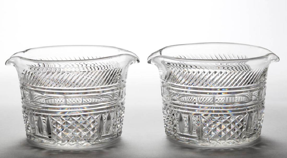 CUT GLASS RINSERS, PAIR: CUT GLASS RINSERS, PAIR, geometrical pattern of diagonal ribs over a chain of cut panels over split vesicas alternating with diamond point, rayed bases. Probably English. 20th century. 3 3/4" H, 4 3/4