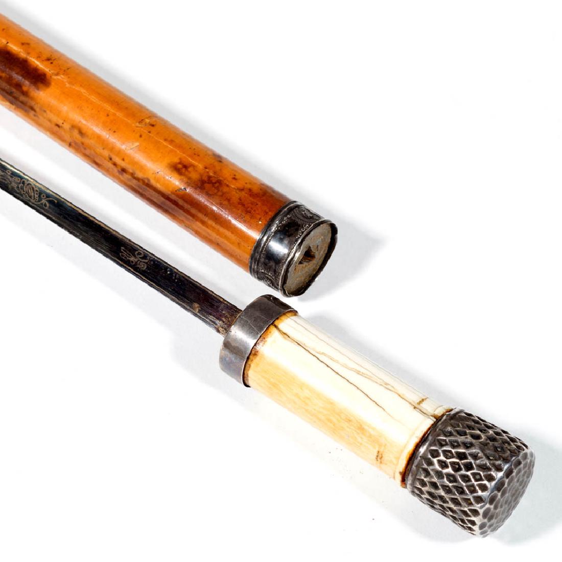 BRITISH / CONTINENTAL SWORD CANE / WALKING STICK: BRITISH / CONTINENTAL SWORD CANE / WALKING STICK, bone handle and marked sterling silver mounts, tapered cylindrical shaft concealing 23-inch blade retaining much original bluing, likely original meta