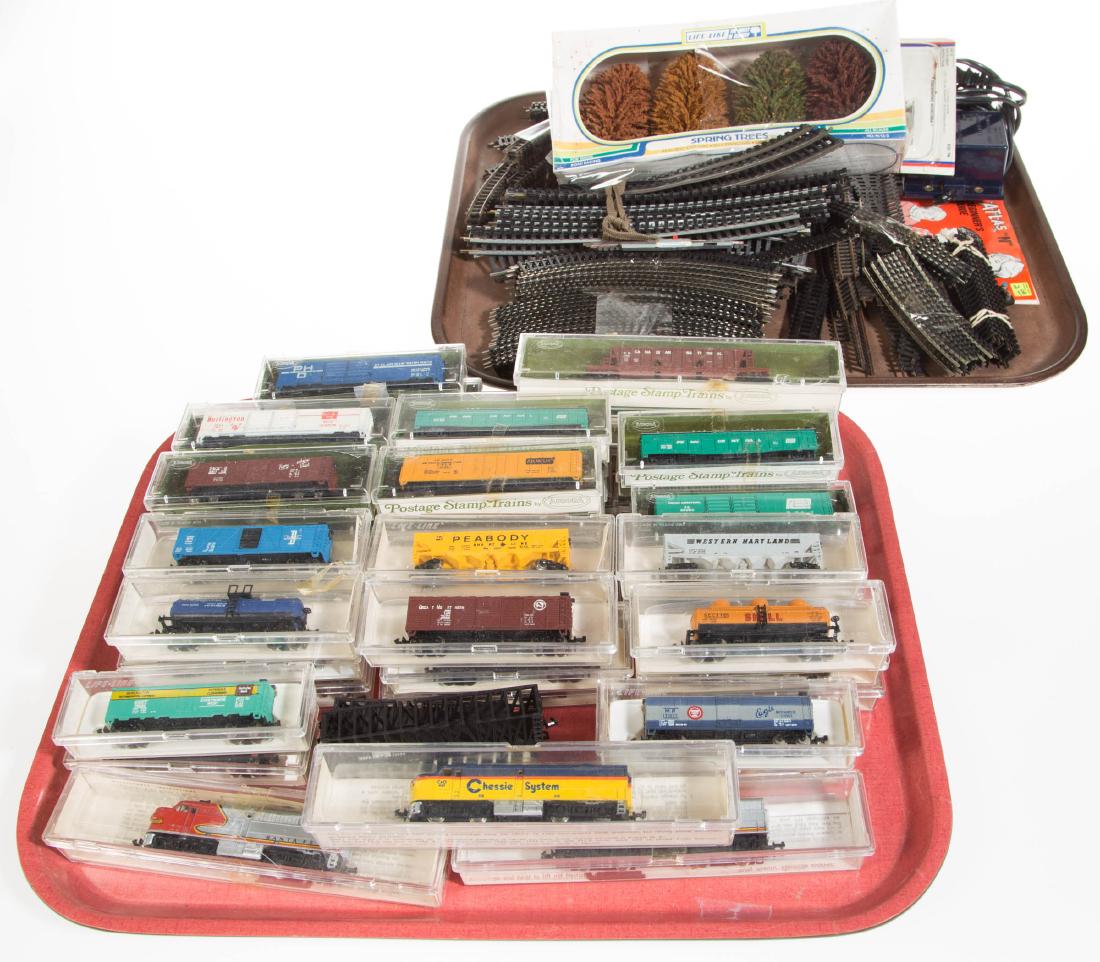 N-SCALE TRAIN ASSORTMENT: N-SCALE TRAIN ASSORTMENT, uncounted lot, including 23 Aurora Postage Stamp cars, three Life-Like engines, and 22 Life-Like cars. Most with boxes.Second half 20th century. Various sizes.Most in very go