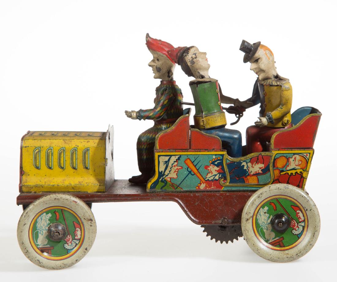 HANS EBERL TIN TOY WIND-UP CLOWN CAR: HANS EBERL TIN TOY WIND-UP CLOWN CAR,lettered to back panel "TA-RA-RA-BUMM" with Hans Eberl trademark.First quarter 20th century. 7 1/2" LOA.Good condition overall, expected wear, etc., lacking steeri
