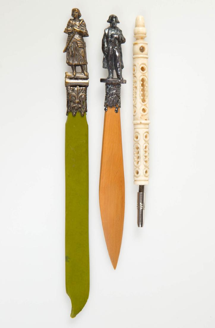 CARVED BONE / BAKELITE STANHOPE FRENCH VIEW ARTICLES,: CARVED BONE / BAKELITE STANHOPE FRENCH VIEW ARTICLES, LOT OF THREE,comprising two letter openers, one having a green bakelite knife and a metal cast design of Joan of Arc and "PARIS" with four views a