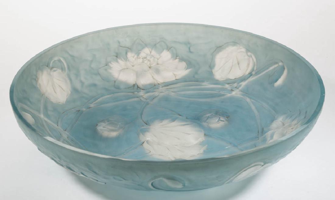 PHOENIX / CONSOLIDATED WATERLILY CONSOLE BOWL: PHOENIX / CONSOLIDATED WATERLILY CONSOLE BOWL, colorless with blue staining, design with three open blooms and three bulbs to the interior, factory-polished rim. Consolidated Lamp & Glass Co. and Phoe