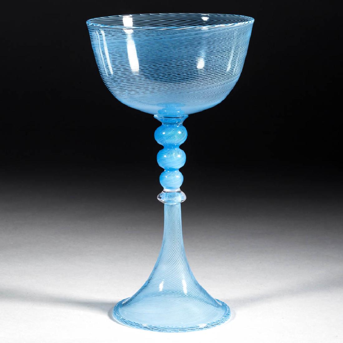 JEFF MACK STUDIO GLASS CHALICE: JEFF MACK STUDIO GLASS CHALICE, turquoise blue with delicate mezza filigrana decoration, Venetian style with triple-knop stem and trumpet foot, signed "TMA glass" under the foot. Accompanied with a la