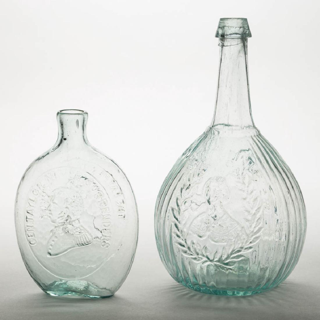 GI-41 AND GI-103 FLASKS, LOT OF TWO: GI-41 AND GI-103 FLASKS, LOT OF TWO, aquamarine, each with a rough pontil mark. United States. 1840-1870. 10 1/4" H GI-103, 6 3/4" H GI-41.Jenny Lind example undamaged with minor overall wear, Washing
