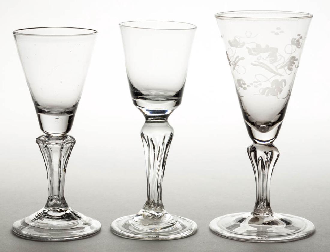 CONTINENTAL FREE-BLOWN MOLDED-PEDESTAL WINE GLASSES,: CONTINENTAL FREE-BLOWN MOLDED-PEDESTAL WINE GLASSES, LOT OF THREE, colorless non-lead glass, comprising a round funnel bowl and two pointed round funnel bowls, one with engraved foliate decoration, fi