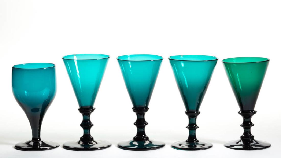 ENGLISH FREE-BLOWN COLORED GLASS WINE GLASSES, LOT OF: ENGLISH FREE-BLOWN COLORED GLASS WINE GLASSES, LOT OF FIVE, teal and emerald green lead glass, comprising an ogee bowl raised on a drawn stem, and four conical bowls raised on button stems, one rough