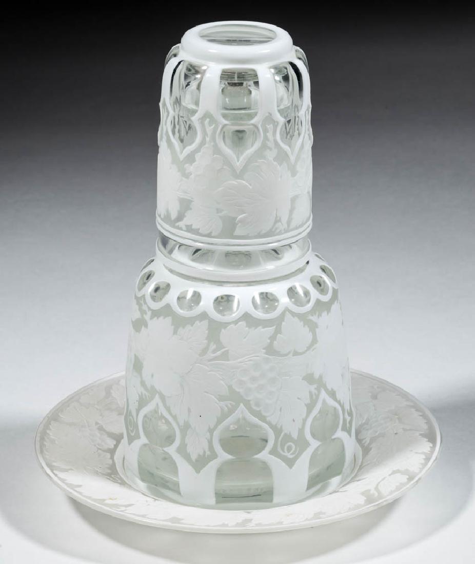 BOHEMIAN CAMEO AND CUT GLASS TUMBLE-UP AND UNDERPLATE: BOHEMIAN CAMEO AND CUT GLASS TUMBLE-UP AND UNDERPLATE, opaque white to colorless, tumble-up with a punty and Moorish Windows motif, original stopper, each with a matching fine Vintage cameo decoration