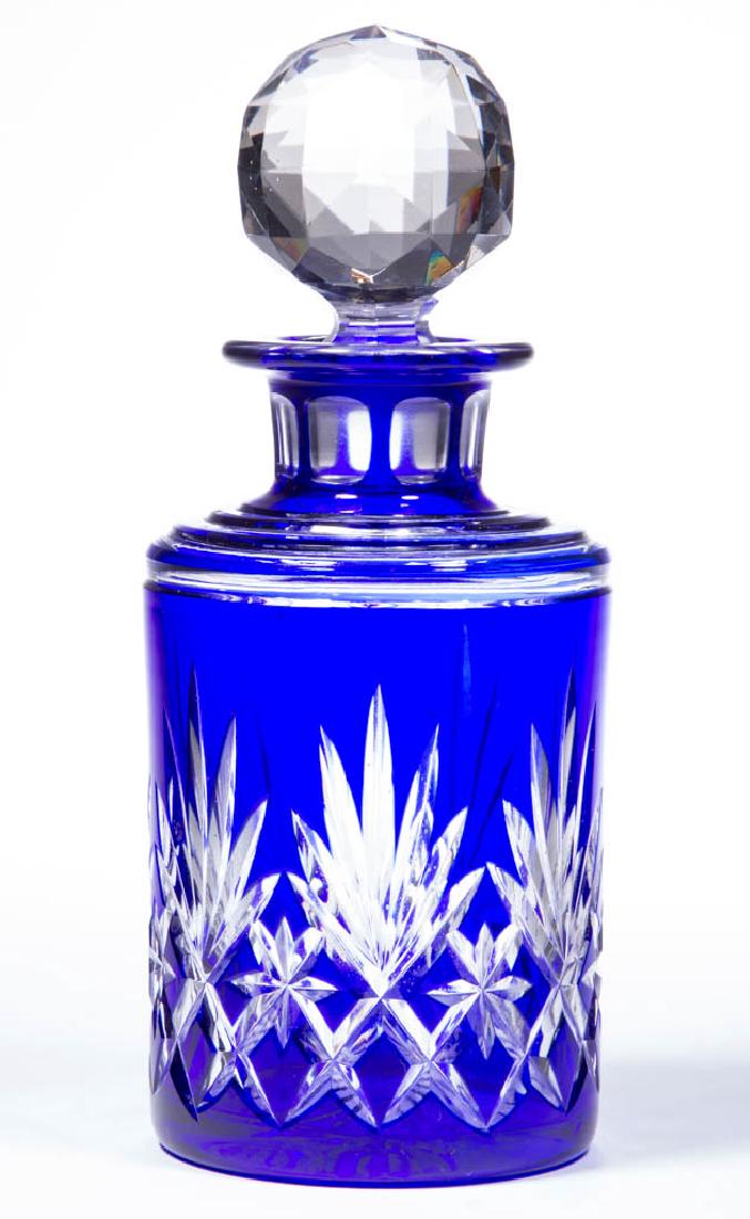 CUT OVERLAY STAR, DIAMOND, AND FAN COLOGNE BOTTLE: CUT OVERLAY STAR, DIAMOND, AND FAN COLOGNE BOTTLE, deep cobalt blue to colorless, cylindrical form with two-step shoulder, panel-cut neck, factory-polished top of flanged mouth, and ray-cut base, orig