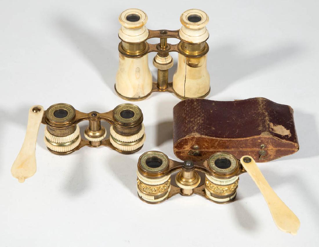 ASSORTED BRASS AND BONE OPERA GLASSES, LOT OF THREE: ASSORTED BRASS AND BONE OPERA GLASSES, LOT OF THREE, brass frames, comprising two examples with handles and raised lettering to eye cups, including "PAR BREVET D'INVENTION ET DE PERFECTION", raised sc