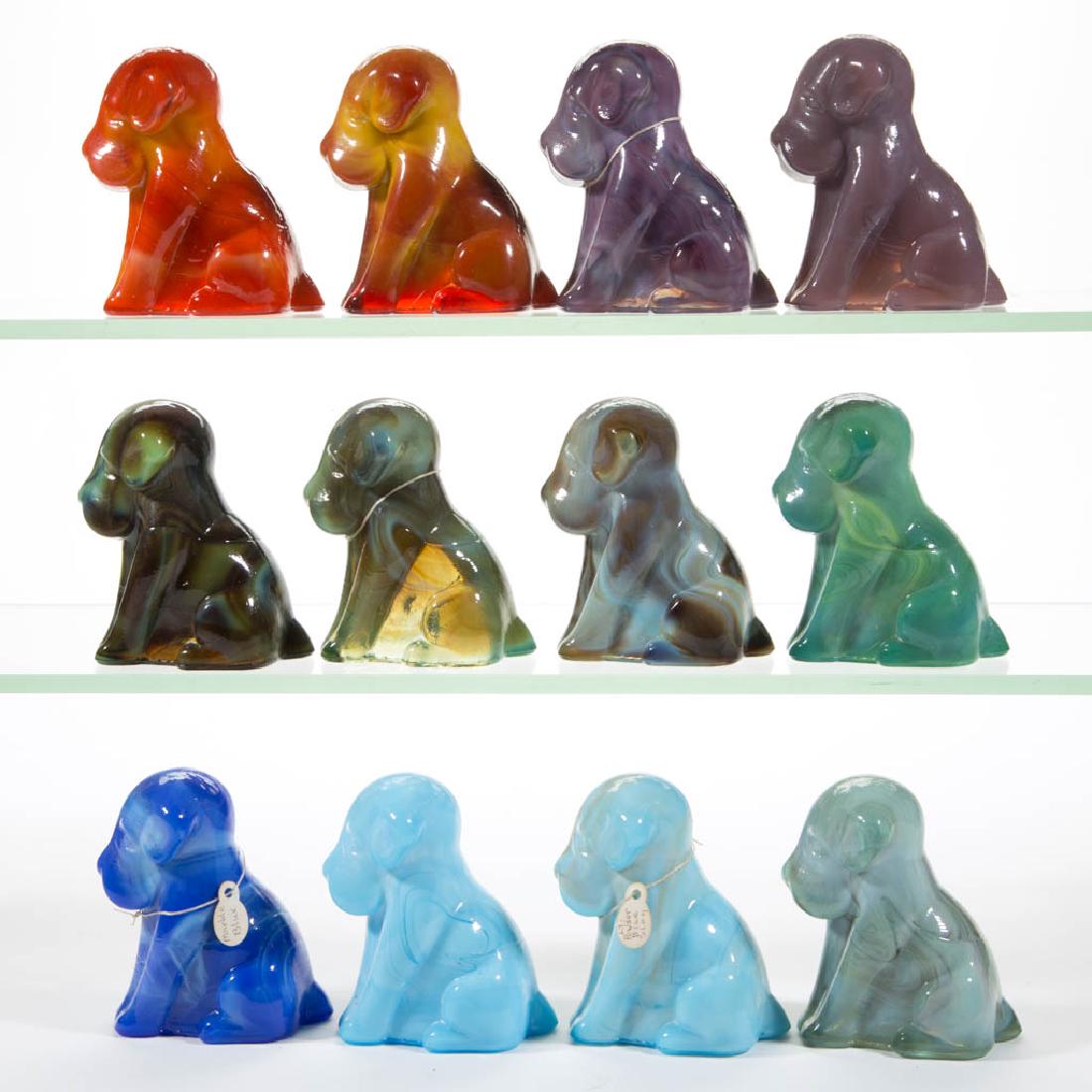 DEGENHART GLASS DOG / POOCH FIGURES, LOT OF 12: DEGENHART GLASS DOG / POOCH FIGURES, LOT OF 12, various colors, including a Bloody Mary / Tomato, a Fantastic, an Old Lavender, and various blue and green slag colors. Each with Degenhart "D" in heart