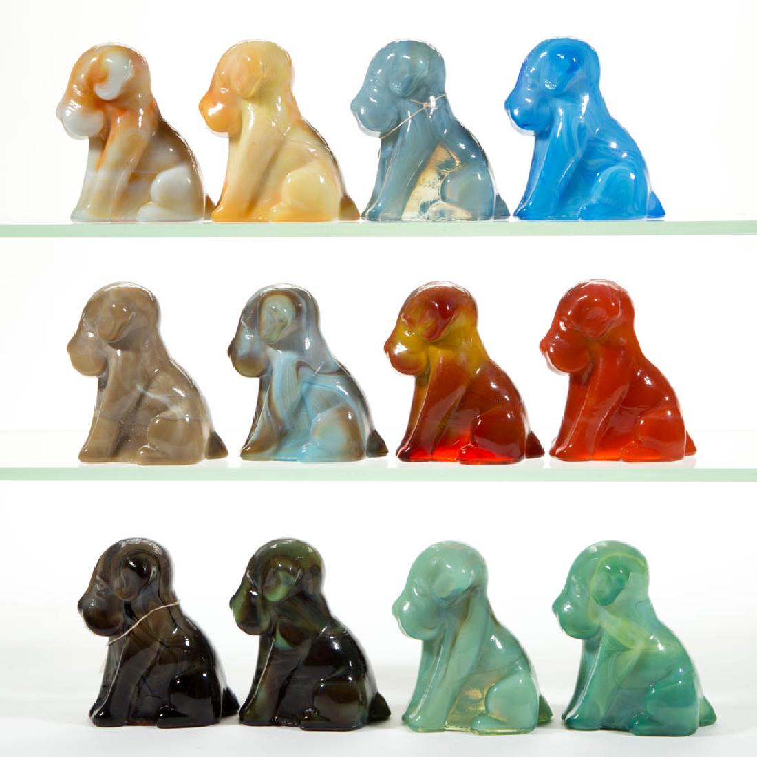DEGENHART GLASS DOG / POOCH FIGURES, LOT OF 12: DEGENHART GLASS DOG / POOCH FIGURES, LOT OF 12, various colors, including a Bloody Mary / Tomato, a Fantastic, a dark Toffee Slag, and a Smoky Blue. Each with Degenhart "D" in heart trademark. Crystal