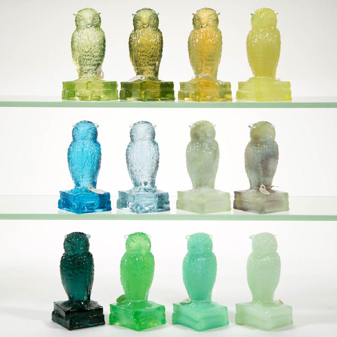 DEGENHART GLASS OWL FIGURES, LOT OF 12: DEGENHART GLASS OWL FIGURES, LOT OF 12, various colors, all of which react to black light, including a dark Teal, an Apple Green, a Blue Bell, and a Lemon. Each with Degenhart "D" to underside. Crysta