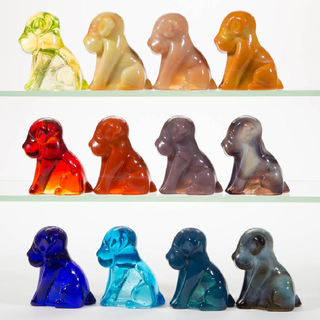 DEGENHART GLASS DOG / POOCH FIGURES, LOT OF 12: DEGENHART GLASS DOG / POOCH FIGURES, LOT OF 12, various colors, including a Bloody Mary / Tomato, a Buttercup Slag, a Lavender Slag, a Cobalt Blue, a Tangerine, an Ivory Slag, and a Canary (black ligh
