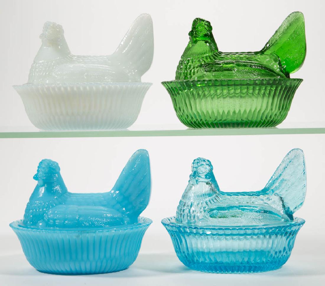 DEGENHART GLASS HEN ON NEST COVERED DISHES, LOT OF FOUR: DEGENHART GLASS HEN ON NEST COVERED DISHES, LOT OF FOUR, comprising a Milk Blue, a Snow White, an Emerald Green, and a Blue Bell. Each with Degenhart "D" in heart trademark. Crystal Art Glass Co., Cam