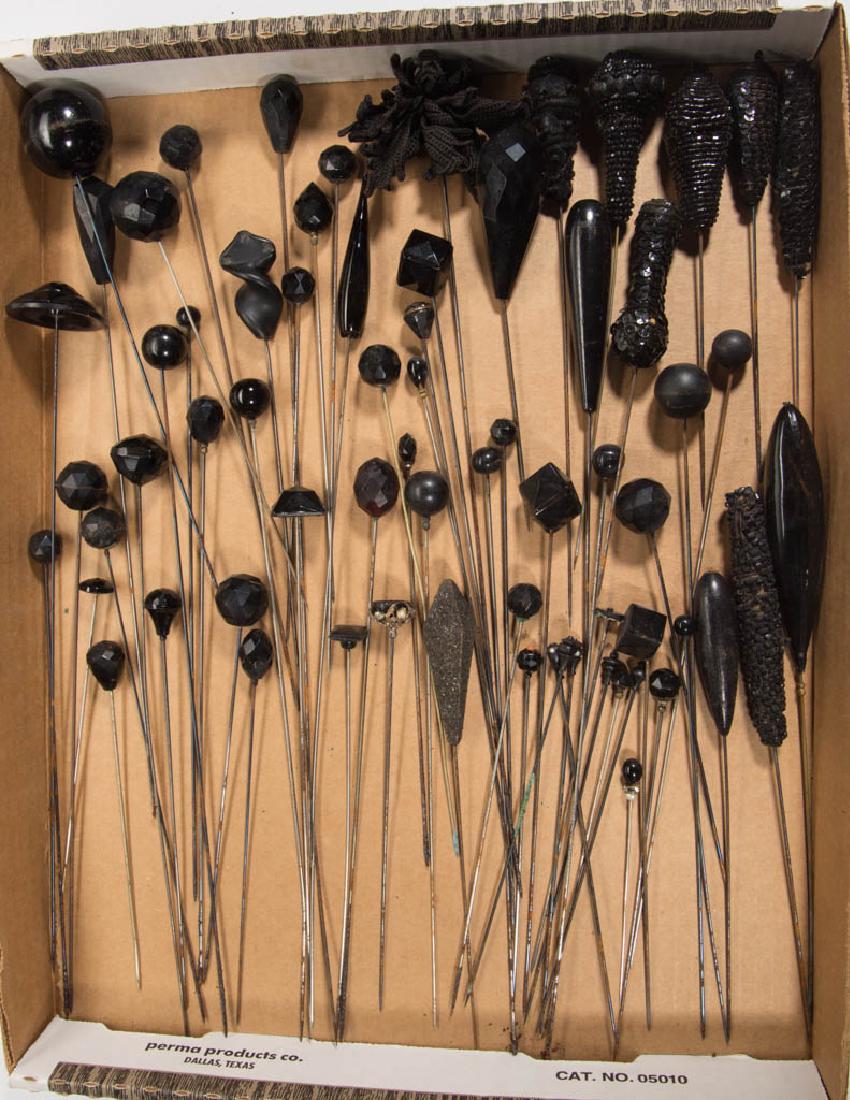ANTIQUE / VINTAGE MOURNING HATPINS: ANTIQUE / VINTAGE MOURNING HATPINS, uncounted lot, including glass, wood, fabric, beads, etc., some with knopped collar. Together with a hatpin reference volume. Fourth quarter 19th/first quarter 20th