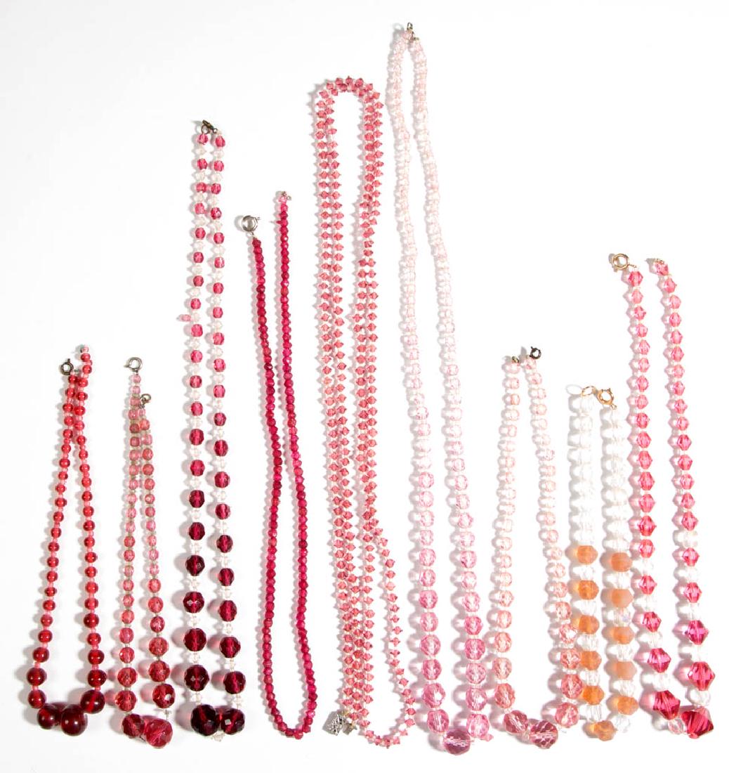 ASSORTED ANTIQUE / VINTAGE FACETED / MOLDED GLASS BEAD: ASSORTED ANTIQUE / VINTAGE FACETED / MOLDED GLASS BEAD COSTUME JEWELRY NECKLACES, LOT OF TEN, including solid pink strands and pink/translucent strands, various clasps. Unmarked. 20th Century. 14" to