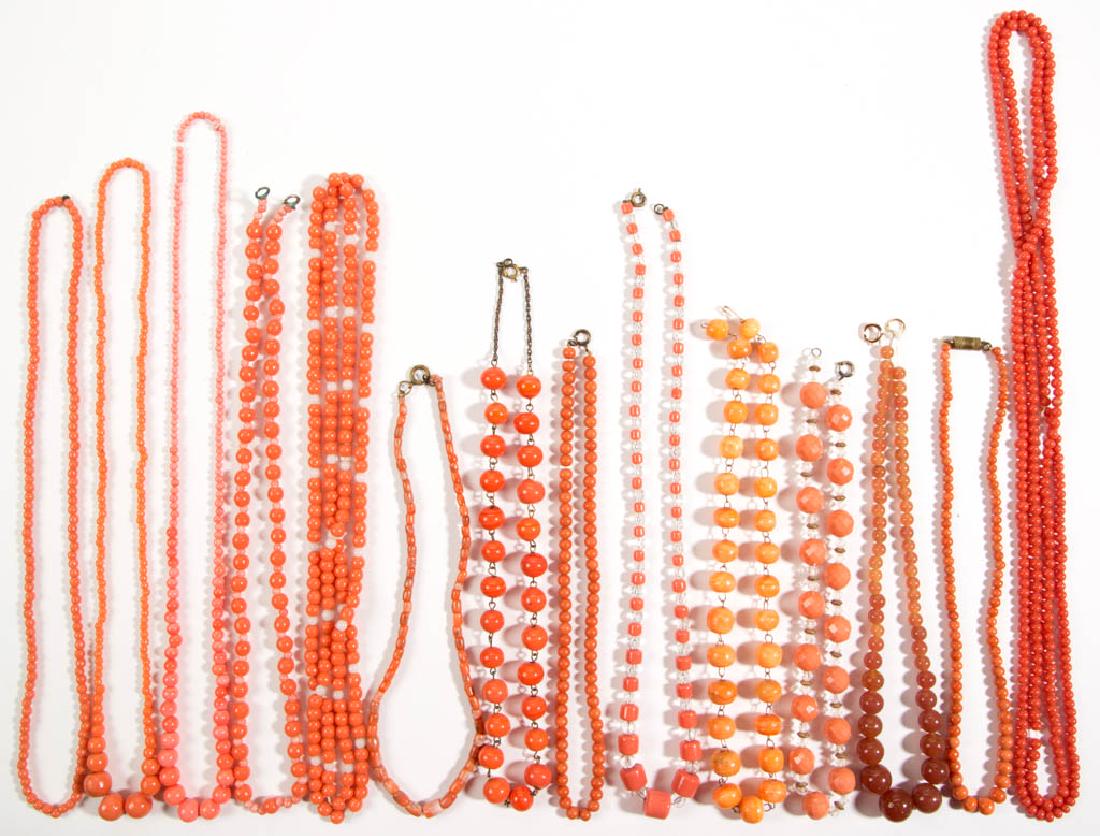 ASSORTED ANTIQUE / VINTAGE FACETED / MOLDED GLASS BEAD: ASSORTED ANTIQUE / VINTAGE FACETED / MOLDED GLASS BEAD COSTUME JEWELRY NECKLACES, LOT OF 14, all having coral/pink coloring, some with various clasps. Unmarked. 20th century. 14 1/2" to 60" LOA.Releas