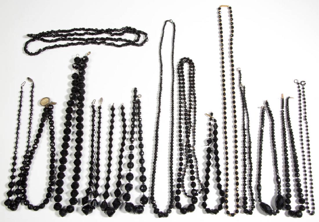 ASSORTED ANTIQUE / VINTAGE FACETED / MOLDED GLASS BEAD: ASSORTED ANTIQUE / VINTAGE FACETED / MOLDED GLASS BEAD COSTUME JEWELRY NECKLACES, LOT OF 15, all having opaque black coloring, some with various clasps. Unmarked. Primarily first half 20th century. 14