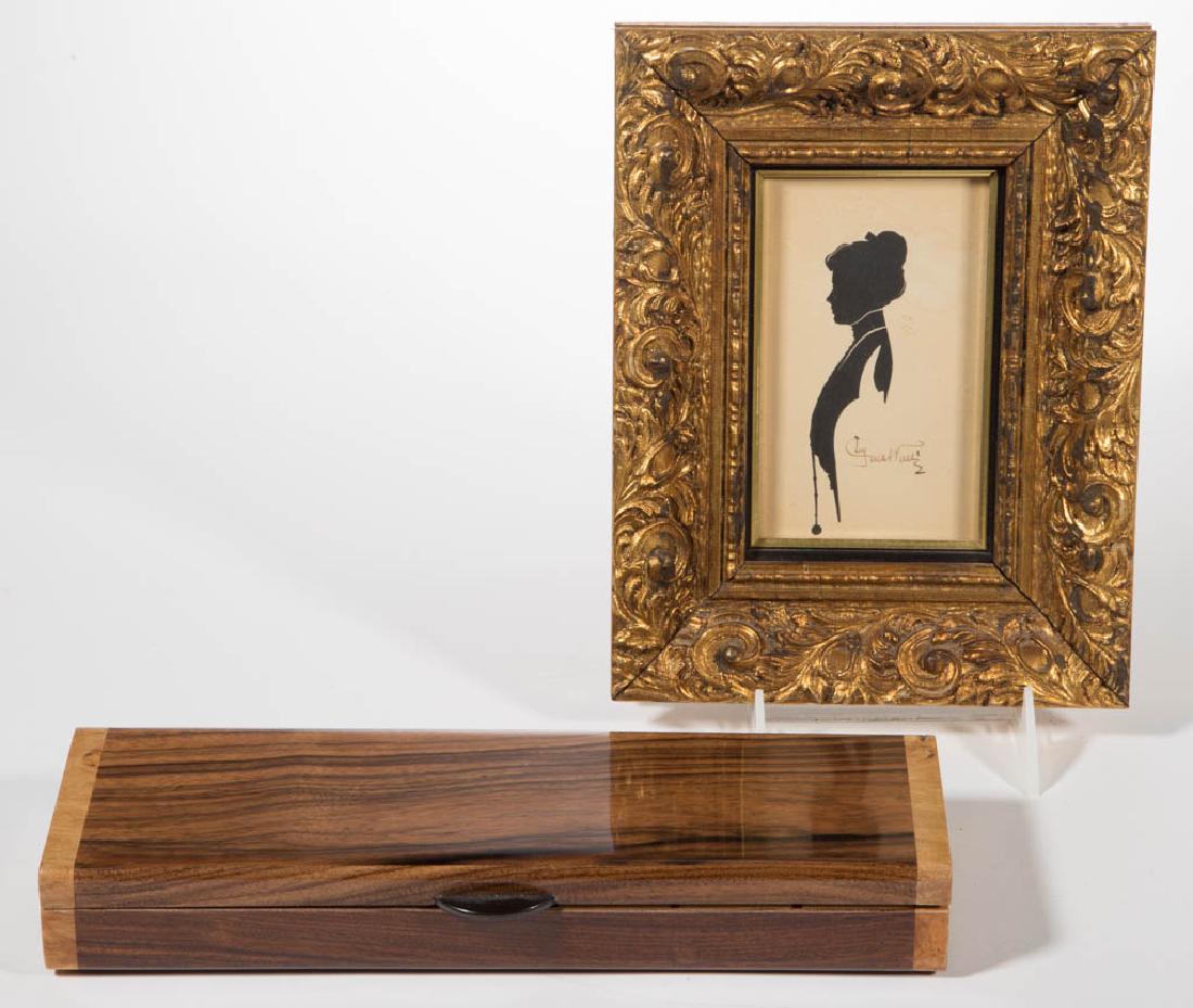 ASSORTED DECORATIVE OBJECTS, LOT OF TWO: ASSORTED DECORATIVE OBJECTS, LOT OF TWO, comprising a cut-and-pasted silhouette of a lady signed by the artist, in a gilded frame, and an exotic-wood box with seven interior compartments, made by Davi