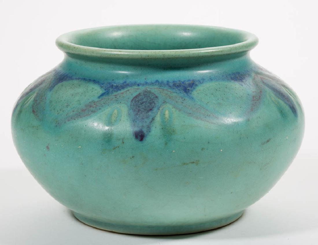 ROOKWOOD HENTSCHEL ART POTTERY VASE / URN: ROOKWOOD HENTSCHEL ART POTTERY VASE / URN, having a polychrome geometric foliate design on shoulder over a matte green glaze. Marked with impressed Rookwood logo and 14 rays, "XV / 494B" below and art