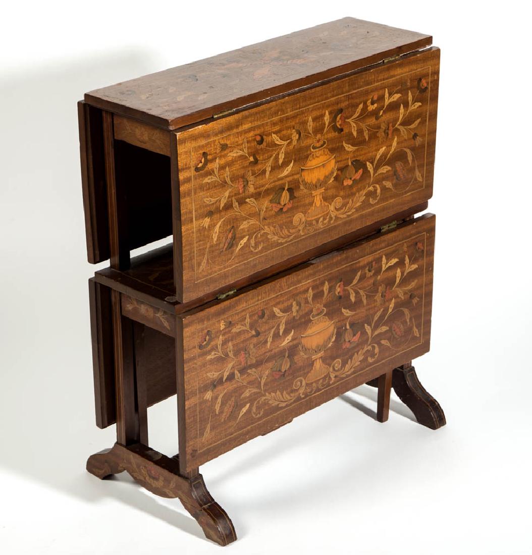 EDWARDIAN MAQUERTY-INLAID MAHOGANY TWO-TIER FALL-LEAF: EDWARDIAN MAQUERTY-INLAID MAHOGANY TWO-TIER FALL-LEAF STAND, each tier fitted with two hinged leaves, the whole raised on a trestle-style base, tops and leaves with intricate urn an scrolling foliate 