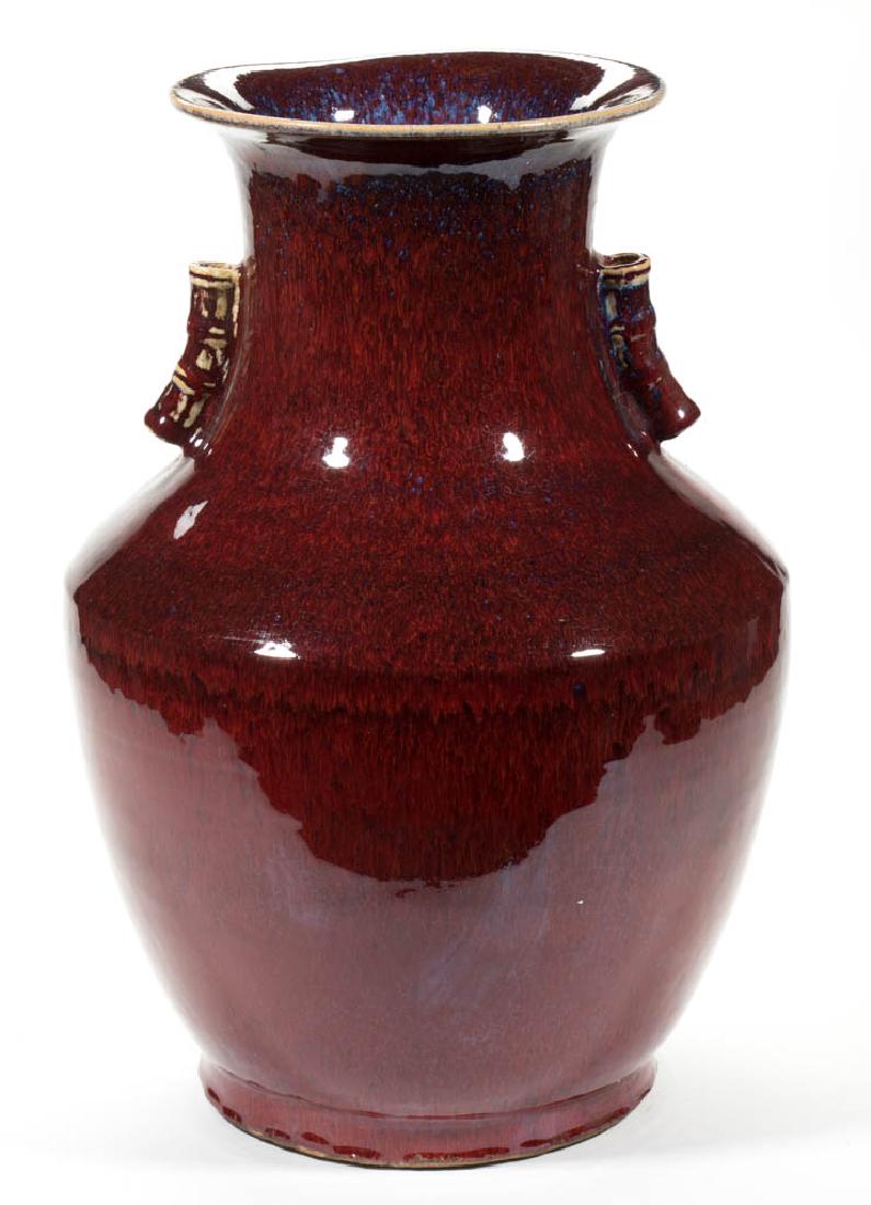 CHINESE FLAMBE / OXBLOOD / SANG DE BEOUF CERAMIC FLOOR: CHINESE FLAMBE / OXBLOOD / SANG DE BEOUF CERAMIC FLOOR VASE, having a deep overall red glaze and areas of purple on rim and handle, baluster form with flared rim and handles modeled similarly to bambo