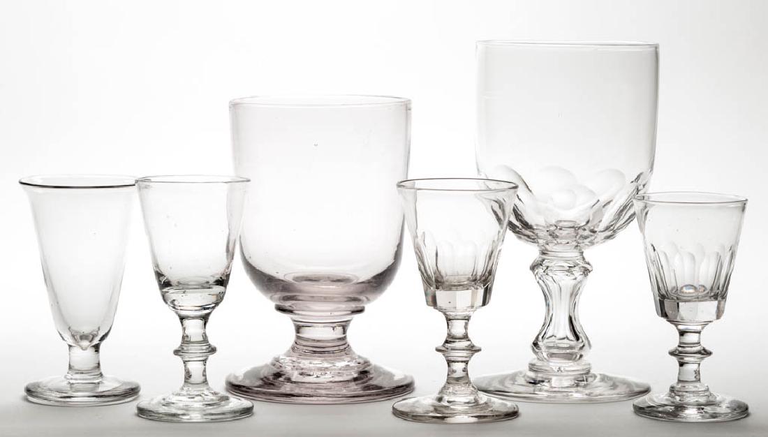ASSORTED FREE-BLOWN GLASS DRINKING ARTICLES, LOT OF SIX: ASSORTED FREE-BLOWN GLASS DRINKING ARTICLES, LOT OF SIX, colorless, comprising a wine, firing glass, and chalice, and two cut-fluted wines and a cut-fluted chalice. Various makers. First half 19th cen