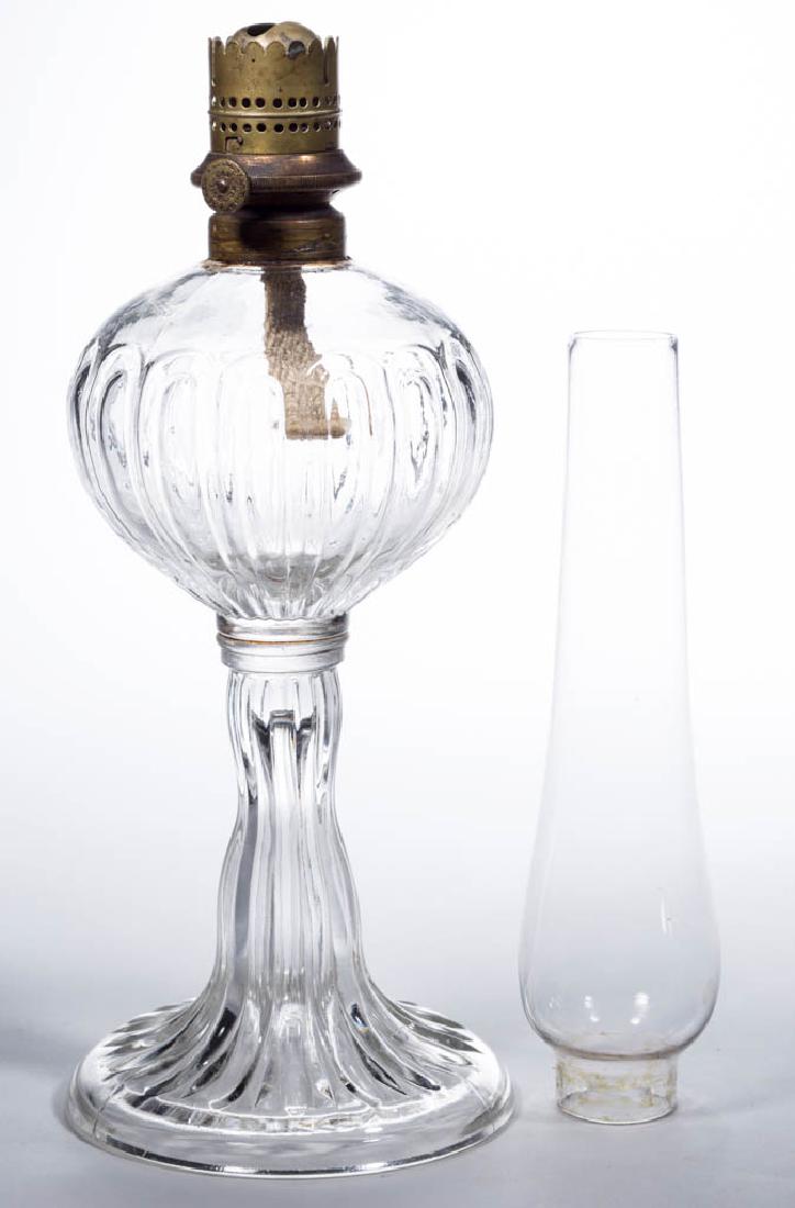 WADE & BURNHAMS VIENNA KEROSENE SLIP BURNER: WADE & BURNHAMS VIENNA KEROSENE SLIP BURNER, thumbwheel marked "WADE & BURNHAMS PATENT APRIL. 6. 1858.". period colorless slip chimney. Fitted on a colorless M'Kee Waisted Broad Rib stand lamp, No. 1 