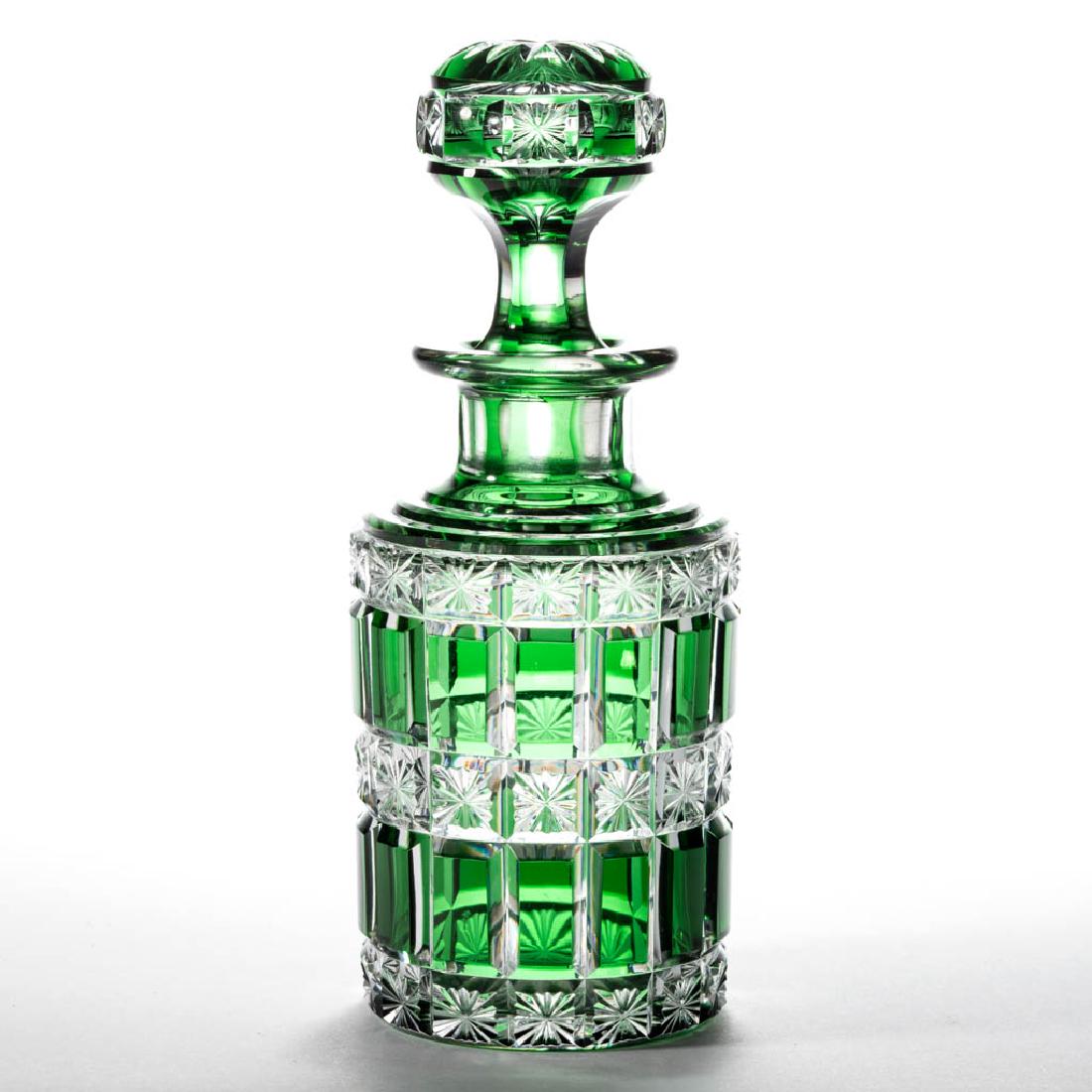 CUT OVERLAY PANEL AND STAR COLOGNE BOTTLE: CUT OVERLAY PANEL AND STAR COLOGNE BOTTLE, green to colorless, large size, cylindrical form with two-step shoulder, panel-cut neck, flanged mouth, and ray-cut base, original air-trap stopper numbered