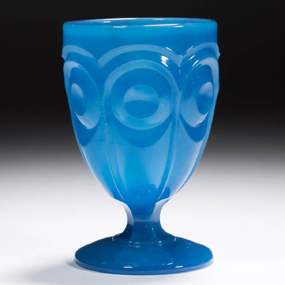 BULL'S EYE / LAWRENCE (OMN) EGG CUP / POMADE: BULL'S EYE / LAWRENCE (OMN) EGG CUP / POMADE, translucent starch blue, deep cup raised on a hexagonal stem and plain circular foot. Boston & Sandwich Glass Co. and others. 1850-1870. 4" H, 2 1/2" D ri