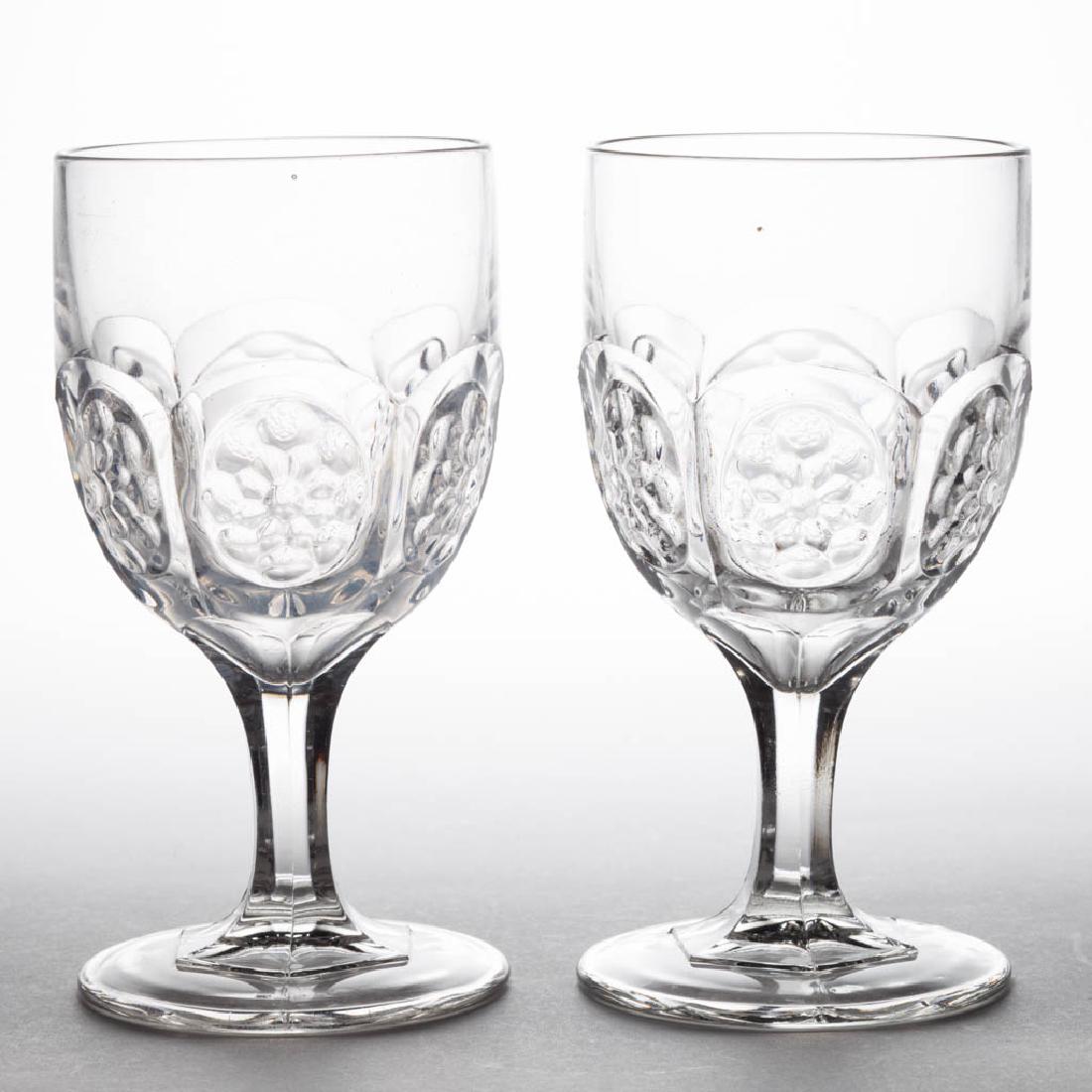 FLOWER MEDALLION PAIR OF GOBLETS: FLOWER MEDALLION PAIR OF GOBLETS, colorless lead glass. Boston & Sandwich Glass Co. 1865-1880. 6 1/8" H. Undamaged with one having minor wear. Literature: Parallels Barlow/Kaiser - The Glass Industry 