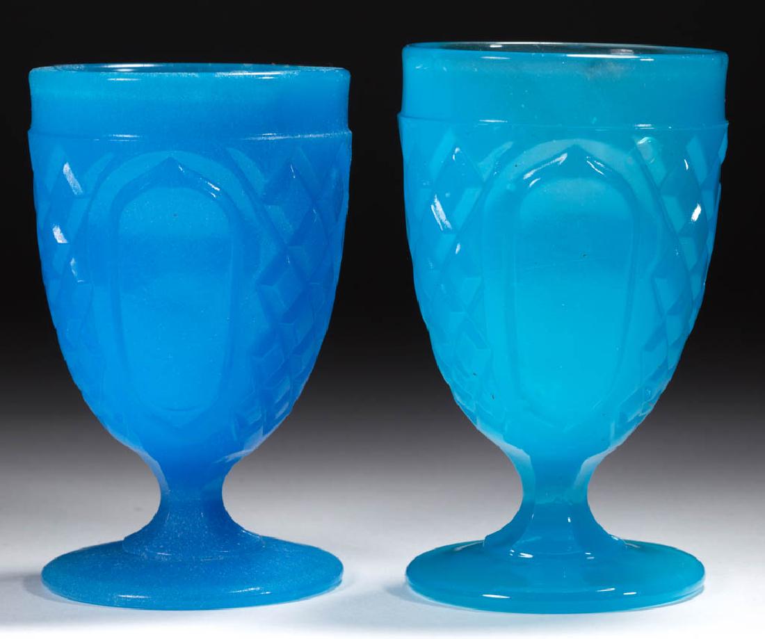LATTICE AND OVALS / FLAT DIAMOND AND PANEL (OMN) EGG: LATTICE AND OVALS / FLAT DIAMOND AND PANEL (OMN) EGG CUPS / POMADES, LOT OF TWO, translucent deep starch blue with a lightly sanded surface and translucent bright starch blue, each with 12 rays under