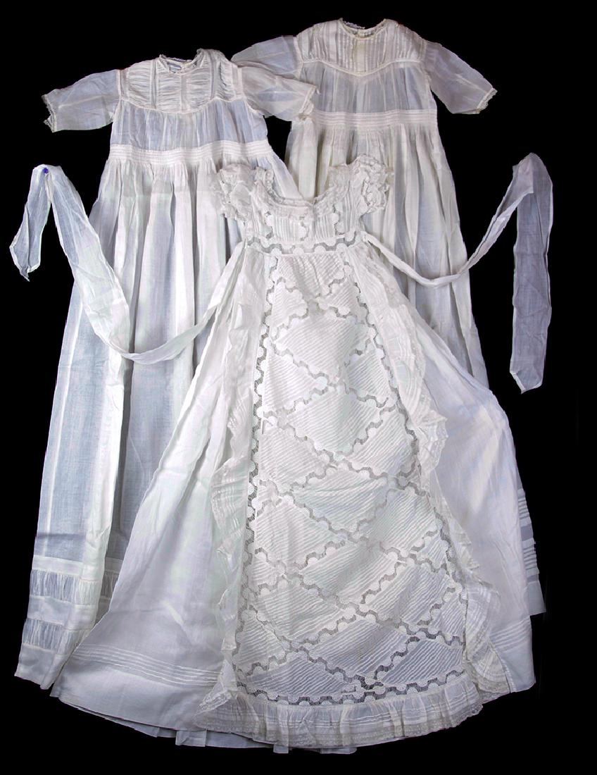 NEWBORN / INFANT GOWNS / DRESSES, LOT OF THREE: NEWBORN / INFANT GOWNS / DRESSES, LOT OF THREE, fine cotton batiste, hand-sewn, comprising a newborn christening gown, and two infant Layette or day dresses; christening gown measures approximately 41