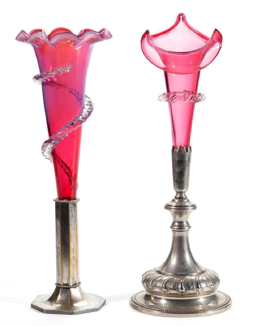 VICTORIAN GLASS TRUMPET VASES, LOT OF TWO: VICTORIAN GLASS TRUMPET VASES, LOT OF TWO, comprising a cranberry example with a Jack-in-the-Pulpit style rim which is fitted in an "EPNS" stand, and a cranberry opalescent with a tooled rim and appli