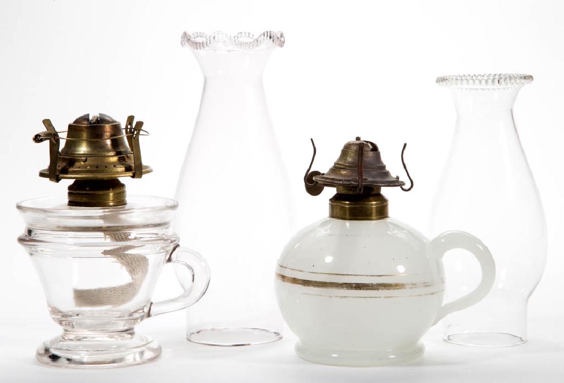 ASSORTED KEROSENE FINGER LAMPS, LOT OF TWO: ASSORTED KEROSENE FINGER LAMPS, LOT OF TWO, comprising a colorless Lomax footed example with 1870 patent date and rough pontil mark under base, and an alabaster/clambroth example with applied handle m