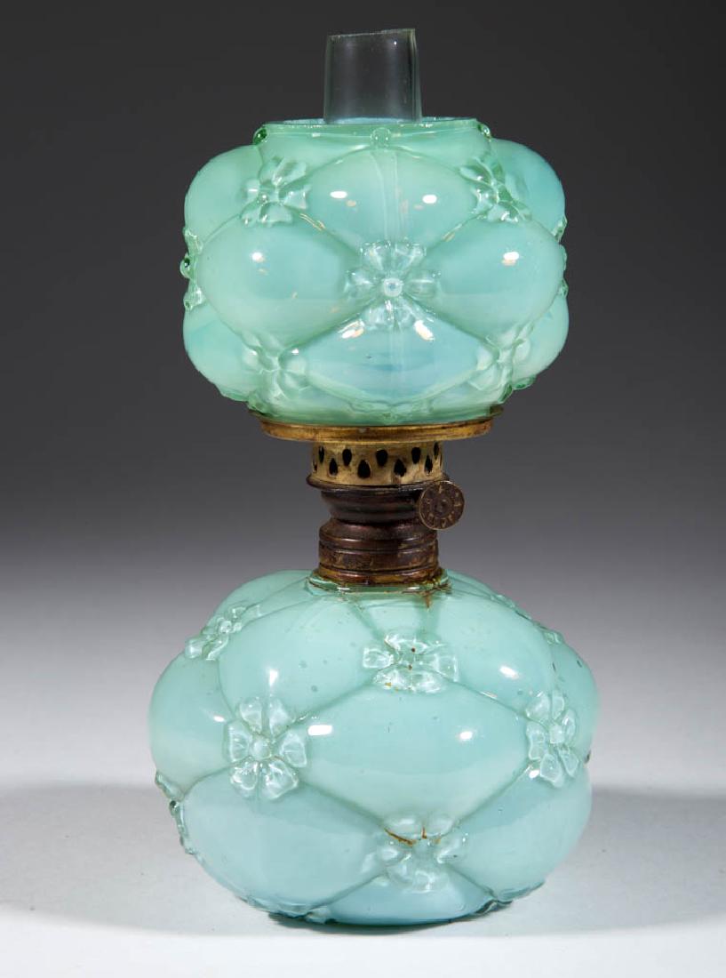 QUILTED PHLOX MINIATURE LAMP: QUILTED PHLOX MINIATURE LAMP, cased blue-green with light opalescence globular-form font, matching patterned ball-form opalescent shade, period collar with patent information. Fitted with a period Nut