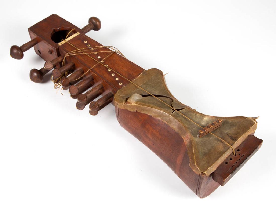 VINTAGE INDIAN SARANGI: VINTAGE INDIAN SARANGI, with bone insets. First half 20th century. 21" H. Lacking one upper peg, loss to parchment, no cracks or breaks. Provenance: Property of a Tennessee estate.