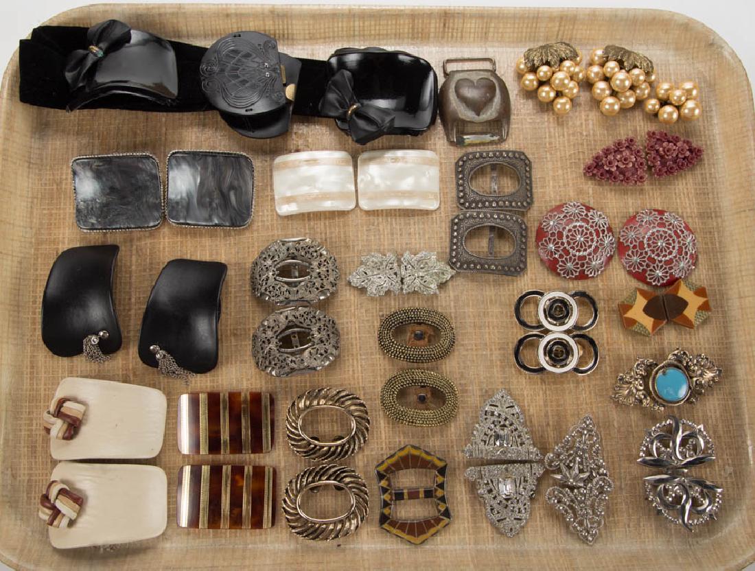 ANTIQUE / VINTAGE BUCKLES AND CLIPS, LOT OF 44 PIECES: ANTIQUE / VINTAGE BUCKLES AND CLIPS, LOT OF 44 PIECES, including rhinestones, cut steel, celluloid, sterling silver, etc. 20th century. Various sizes. Sterling example with moderate chip to blue glass