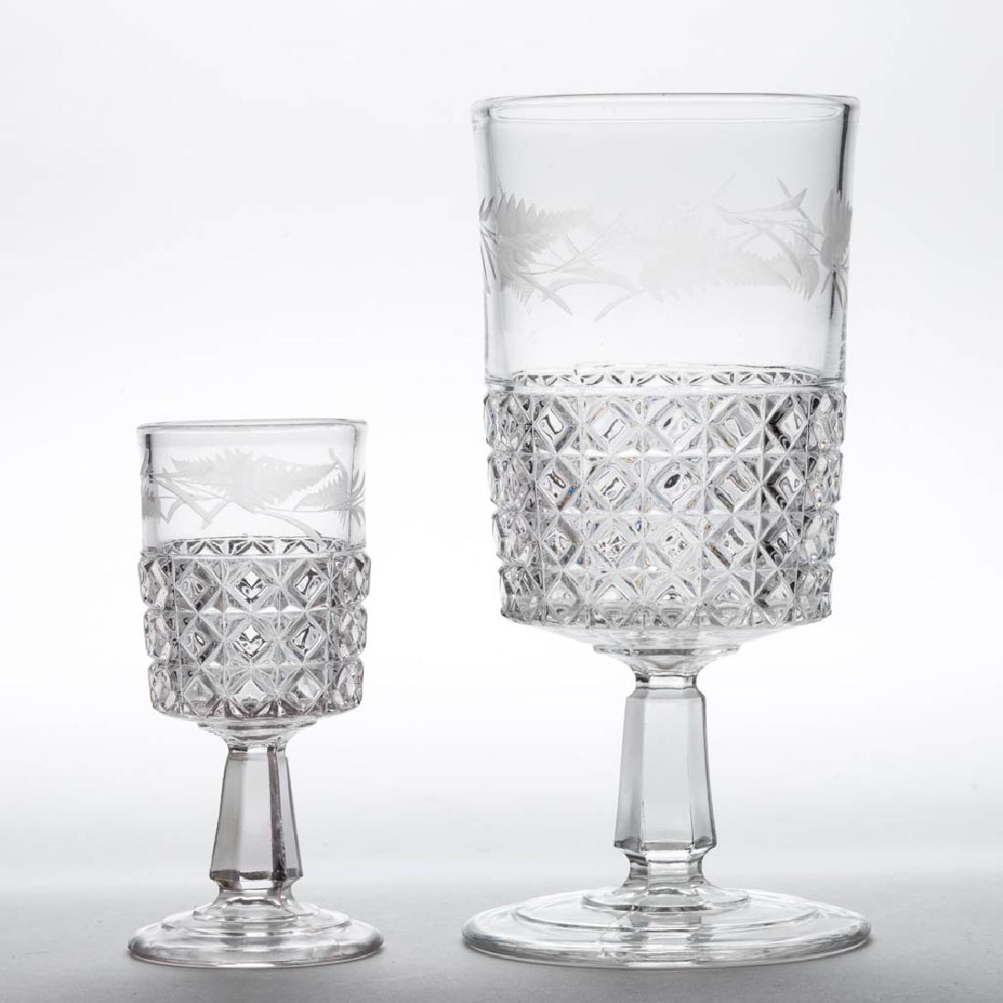 MASCOTTE (OMN) / DOMINION DRINKING ARTICLES, LOT OF TWO: MASCOTTE (OMN) / DOMINION DRINKING ARTICLES, LOT OF TWO, colorless with matching engraved decoration, comprising a goblet and a wine. Ripley & Co. 1884-1891. Goblet: 6 1/2" H, Wine: 4" H. Undamaged. P