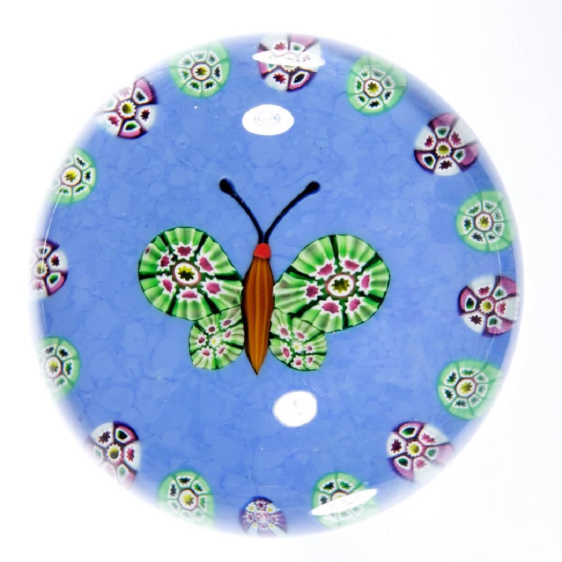PAUL YSART STUDIO ART GLASS MILLEFIORI PAPERWEIGHT: PAUL YSART STUDIO ART GLASS MILLEFIORI PAPERWEIGHT, colorless, depicting a polychrome butterfly with tan body, encompassed by spaced polychrome millefiori canes, all above powder blue ground, signatur
