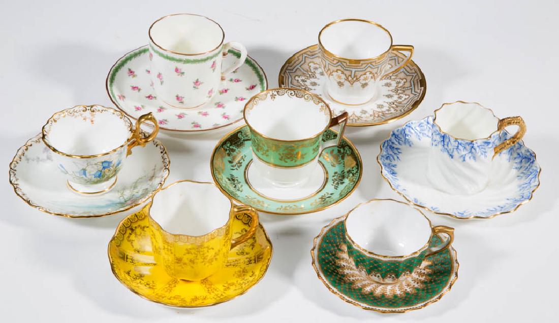ENGLISH DEMITASSE PORCELAIN CUP AND SAUCER SETS, LOT OF: ENGLISH DEMITASSE PORCELAIN CUP AND SAUCER SETS, LOT OF SEVEN, comprising various motifs, all with gilt decoration. Printed marks include "MINTONS", "ROYAL CROWN DERBY", "WEDGWOOD / ETRURIA, ENGLAND",