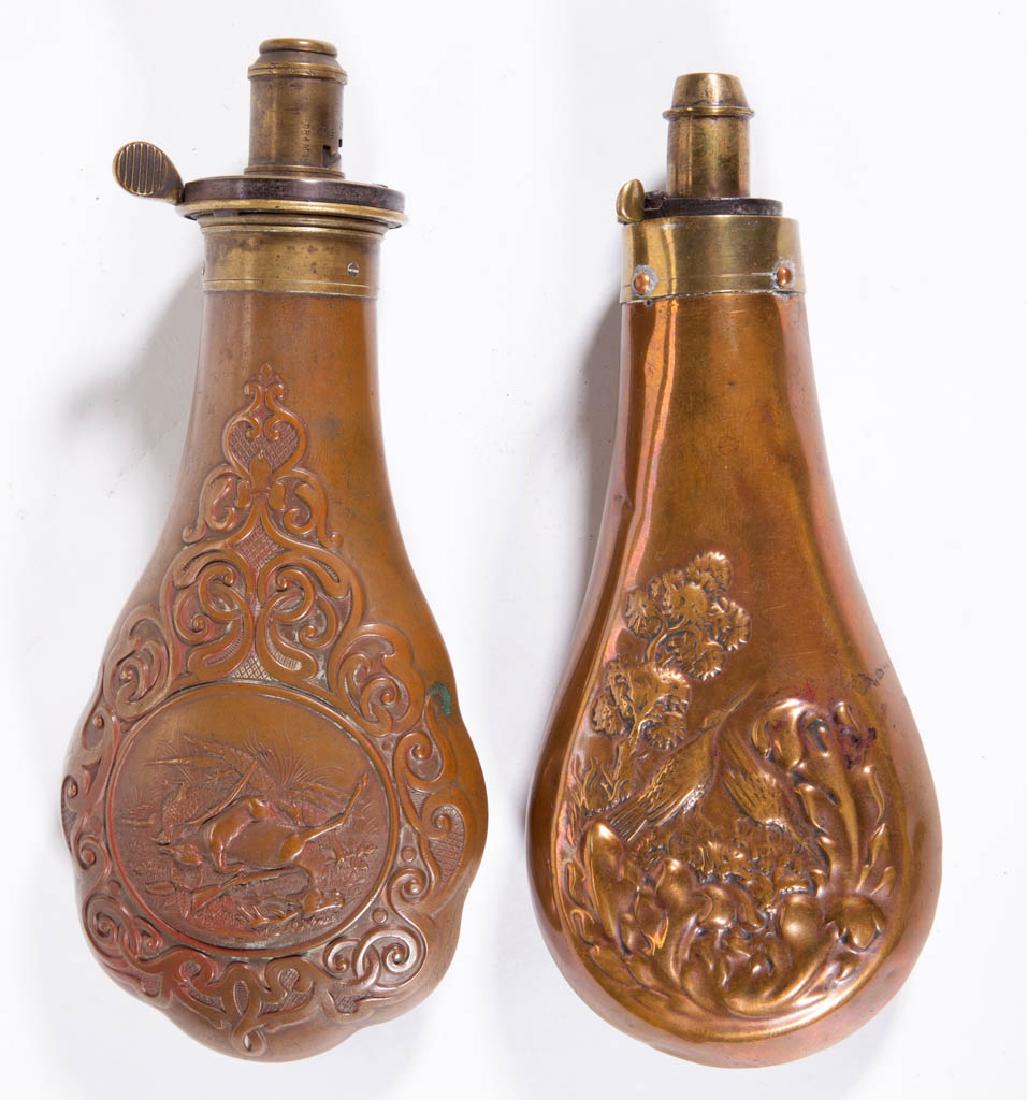 ASSORTED BRASS POWDER FLASKS, LOT OF TWO: ASSORTED BRASS POWDER FLASKS, LOT OF TWO, each with embossed decoration, one with a slain, rabbit, and pheasant, with gun, and the other with two birds. Powder flask with deer is marked "James Dixon &