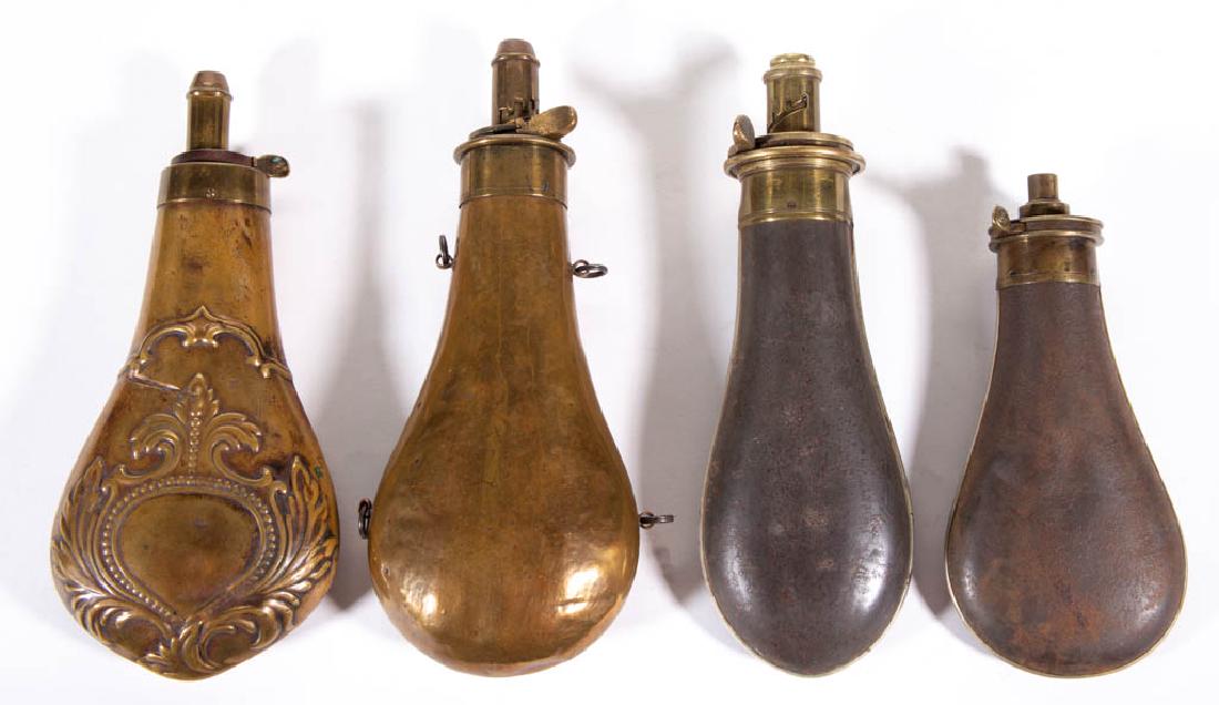 ASSORTED TIN AND BRASS POWDER FLASKS, LOT OF FOUR: ASSORTED TIN AND BRASS POWDER FLASKS, LOT OF FOUR, comprising two tin examples made by G & J.W. Hawksley, brass example by AM Flask & Cap Co, and another with embossed decoration. 19th century. 6 1/2"