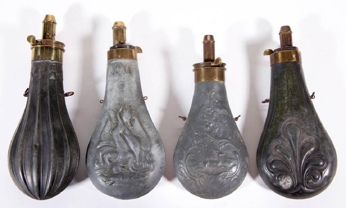 ASSORTED TIN POWDER FLASKS, LOT OF FOUR: ASSORTED TIN POWDER FLASKS, LOT OF FOUR, each with embossed decoration and brass ejectors / measures. One brass ejector marked "DRAMS". 19th century. 7 1/2" to 8 3/4" LOA.Good overall condition, with