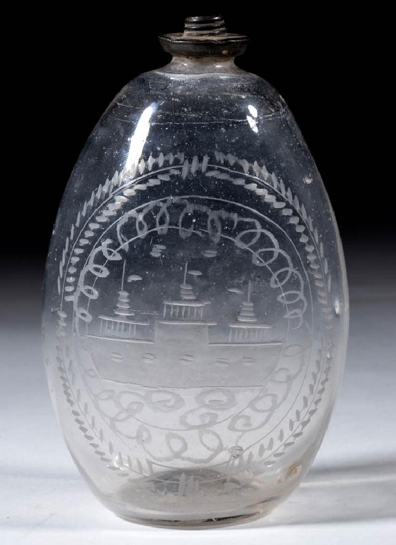FREE-BLOWN AND ENGRAVED GLASS POCKET FLASK: FREE-BLOWN AND ENGRAVED GLASS POCKET FLASK, colorless, flattened ovoid form with nautical decoration enclosed by two bands of swirling and foliate bordering, period pewter collar, rough pontil mark. M