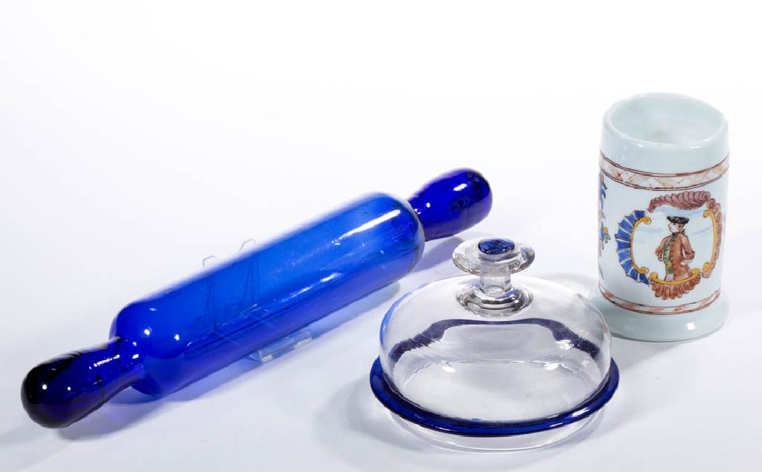 ASSORTED FREE-BLOWN GLASS ARTICLES, LOT OF THREE: ASSORTED FREE-BLOWN GLASS ARTICLES, LOT OF THREE, comprising a free-blown cobalt blue rolling pin, a colorless apothecary jar cover with applied blue decoration, and an opaque white/milk glass free-bl