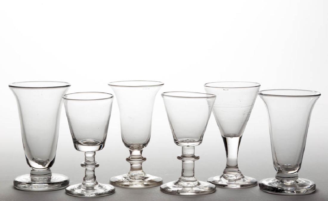 ASSORTED FREE-BLOWN DRINKING VESSELS, LOT OF SIX: ASSORTED FREE-BLOWN DRINKING VESSELS, LOT OF SIX, colorless lead glass, comprising four wines and two firing glasses, each with a rough pontil mark with some being faint. Probably English. 19th centur
