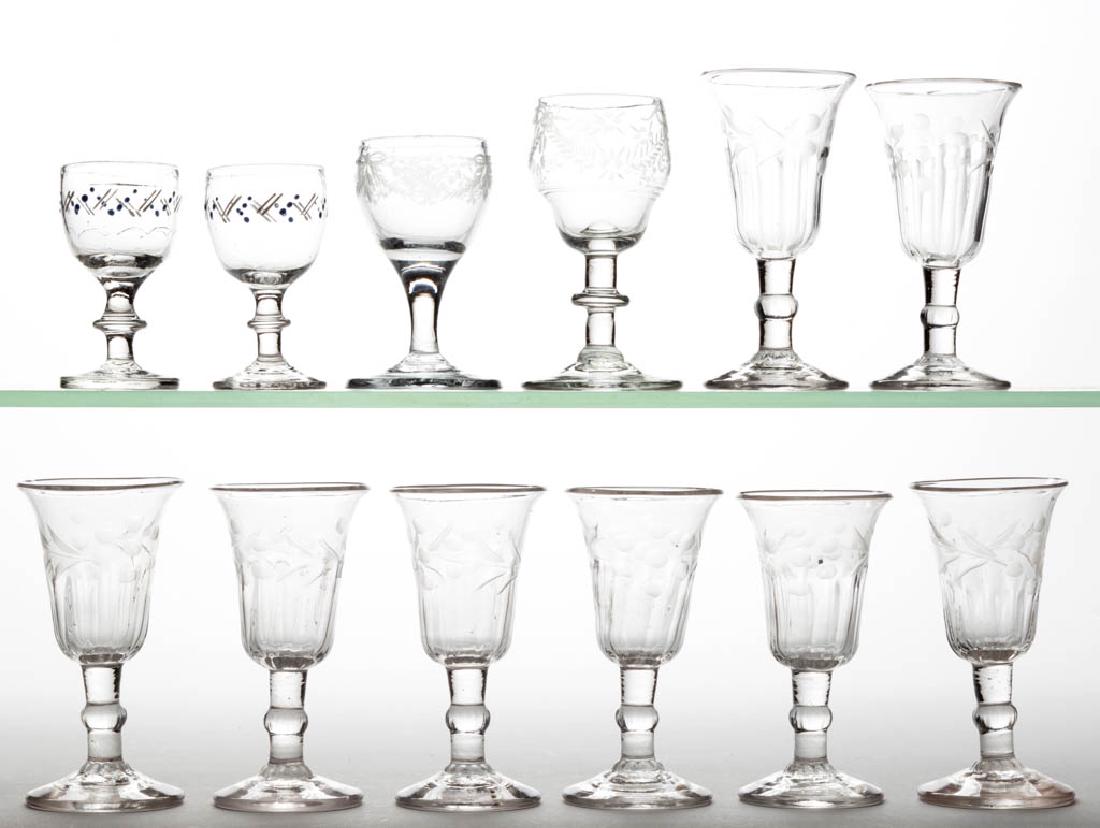 ASSORTED ENGRAVED GLASS WINE GLASSES, LOT OF 12: ASSORTED ENGRAVED GLASS WINE GLASSES, LOT OF 12, colorless lead glass, comprising a set of eight matching molded examples and two free-blown engraved, each with a rough pontil mark. Together with a pa